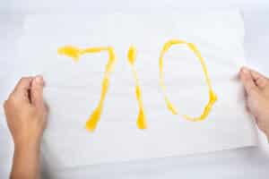 710 cannabis wax day concept, golden dab text in hand.