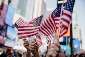 Group of people celebrate a National US Holiday at a parade in Times Square, New York.