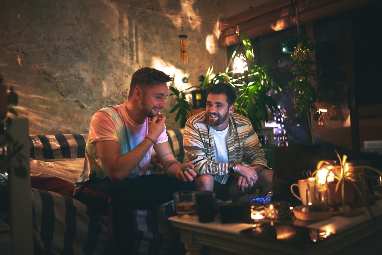 Cropped shot of two handsome young man having a chat while hanging out together at home